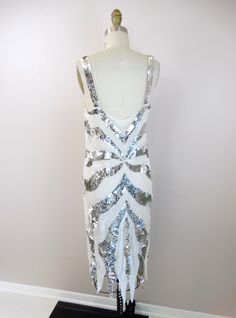 "This is an amazing vintage dress detailed and hand beaded with white beading and silver sequins. It's in perfect condition! Bust - 32\" Waist - 32\" Hips - 36\" Dress Length - 39-45\" This dress comes from a pet-free and smoke-free home. If you would like more info or have any questions, please don't hesitate to ask!" Sequin Dress White, Sequin Dress Silver, Gold Beaded Dress, Sequined Dress, Gown Photos, Dress Silver, Embellished Gown, Sequin Jacket, Beaded Gown