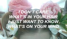 a girl with pink flowers in her hair that says, i don't care what's in your hair just want to know what's on your mind