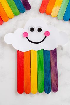 popsicle rainbow craft for kids to make with the clouds and rainbows on them