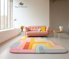 a pink couch sitting on top of a rug in a living room