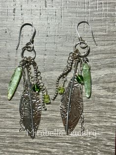 Long boho/hippie dangle earrings.  Sterling silver was formed into a leaf shape, hammered and given a light patina.  There are Peridot and Prehnite  beads that hang from silver chain.  Sterling silver ear wires.   Everything is handmade by me in my home studio in coastal North Carolina using conventional silversmith technique's. Bohemian Nickel-free Leaf-shaped Earrings, Bohemian Leaf-shaped Jewelry With Ear Wire, Bohemian Green Leaf-shaped Jewelry, Bohemian Silver Hammered Earrings, Silver Hammered Bohemian Earrings, Green Leaf-shaped Sterling Silver Earrings, Bohemian Sterling Silver Hammered Earrings, Bohemian Hammered Sterling Silver Earrings, Green Hammered Bohemian Jewelry