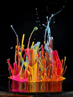 multicolored liquid splashing on top of each other