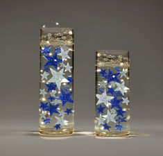 two clear vases with blue and white stars on them, one is lit up