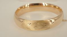 This is an 18k yellow gold bangle bracelet.  This inside of this bangle is 6.75 inches in circumference and is it 14mm wide.  You will not be disappointed with this purchase. **The dark spots that can be seen in some of the pictures are not on the item.  It is caused by the reflection of the camera used to take the photos.**All metal is tested with a Thermo Scientific Niton DXL precision metal Analyzer.*****    JACOBS JEWELERS 2119 MAIN ST DUNEDIN, FL 34698 STORE HOURS MON- SAT 10AM-6PM Guaranteed to be 100% authentic. DO NOT MISS OUT ON THIS BEAUTIFUL BRACELET.  IT IS IN EXCELLENT CONDITION.  WE ALSO SELL OTHER HIGH END JEWELRY.  SO PLEASE LET US KNOW WHAT YOU ARE LOOKING FOR.  IF YOU HAVE ANY QUESTIONS OR WOULD LIKE TO SCHEDULE AN APPOINTMENT PLEASE CONTACT US.  THANK YOU. PAYMENT INFORM Gold Thick Band Bracelet For Formal Occasions, Formal Gold Bracelet With Thick Band, Gold Thick Band Bracelets For Formal Occasions, Luxury Hallmarked Jewelry With Round Band, Oval Fine Jewelry Bangle As Gift, Elegant Oval Cuff Bracelet For Formal Occasions, Luxury Polished Bracelet Jewelry, Adjustable Polished Bangle Jewelry, Elegant Oval Bangle For Gifts