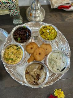 a silver plate topped with different types of food