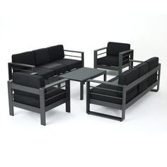 a black couch and chair sitting next to each other on top of a white floor