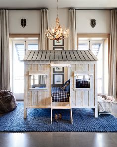 a child's bedroom with bunk beds and a chandelier hanging from the ceiling