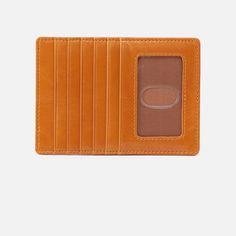 a tan leather wallet is open and has an empty card holder on the front side