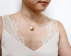 A simple and classic hammered coin necklace with a pendant that hovers over delicate cable chain for a modern sleek look.  Perfect for everyday.  Tumbled for hours to achieve a satin finish.MATERIALStarnish resistant rhodium silver/22k gold plated brassDIMENSIONS22mm (7/8") diameter, hung on an 16" chain with 2" extension.◊ Matching hammered jewelry:  https://www.etsy.com/shop/kindlingandco/search?search_query=hammered◊ Visit our shop: https://www.etsy.com/shop/kindlingandco✨SHOP POLICIES (PLEAS Champagne Necklace, Gold Bridal Necklace, Hammered Jewelry, Pendant Minimalist, Silver Chain Style, Jewelry Card, Coin Necklace, Circle Pendant, Bridal Necklace