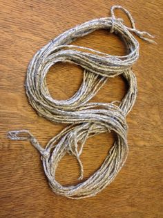 a rope is laying on top of a wooden table and it looks like something out of an old book