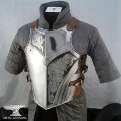 a knight's armor is displayed on a white background with black and brown accents