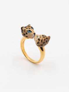 a gold ring with a leopard's head on the front and blue eyes on the back