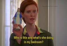 a woman holding a small figurine in her hand with the words who is this and what's she doing in my bedroom?