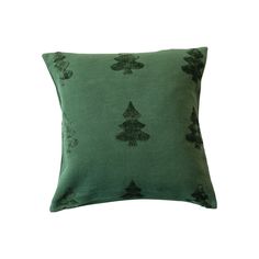 a green pillow with trees on it