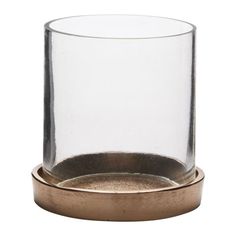 a glass and metal candle holder on a white background