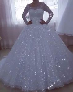 a woman in a white wedding dress posing for the camera