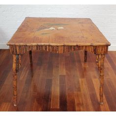 an old wooden table sitting on top of a hard wood floor