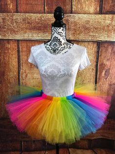 a white shirt and multi colored tutu skirt