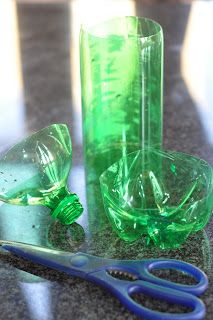 a pair of scissors sitting on top of a table next to some empty glass bottles