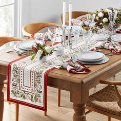 the table is set with white plates and silverware