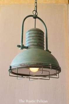 an old fashioned light hanging from a ceiling