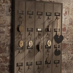 a bunch of keys are hanging on the wall in front of a brick wall with a sign that says top 15 diy holders & racks for your home