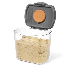 a plastic container filled with sand on top of a white surface