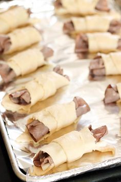 some food is laying on top of tin foil and ready to be cooked in the oven