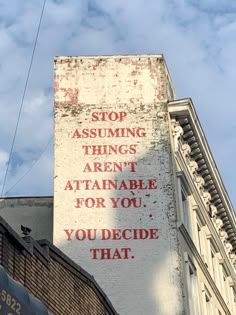 a sign on the side of a building that says stop assuming things aren't attainable for you, you decide that