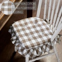 a white rocking chair with a brown and white checkered seat cover on it's back