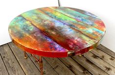 an old table painted with multicolored paint