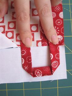 someone is making a paper origami letter with scissors and tape on the cutting board