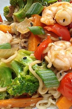 shrimp, broccoli, carrots and noodles on a plate