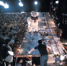 an inflatable ghost walking across a stage surrounded by people