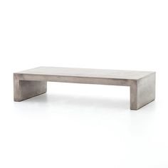 a concrete bench sitting on top of a white floor