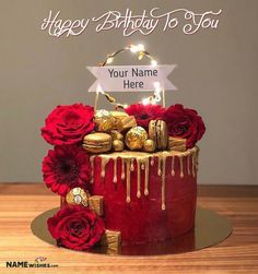 a birthday cake with red roses and chocolates on the top that says, happy birthday to you your name here