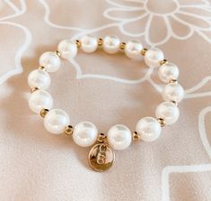 Monogram bracelets make the cutest gift for the junior bridesmaids in your bridal party! Each faux pearl bracelet comes personalized with a gold initial of your choice. Add our signature gift box with a floral insert for an extra charge.
Material: Faux pearls and alternating gold-plated beads.
 Box Style Options
Size:
Diameter(Unstretched): 2.5"
This is a stretch style bracelet. One size fits most. Junior Bridesmaids, Monogram Bracelet, Faux Pearl Bracelet, Gold Initial, Junior Bridesmaid, The Deal, Monogram Letters, Pearl Bracelet, Party Gifts