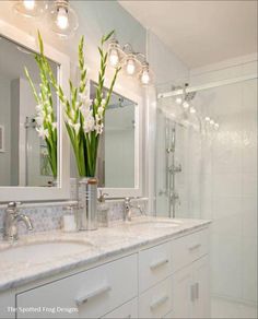 a bathroom with two sinks and a large mirror