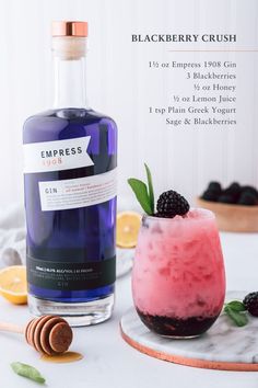 a bottle of blackberry crush next to a glass filled with ice and berries