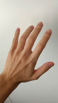 a person's hand reaching up into the air