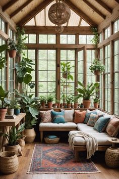 a living room filled with lots of plants and potted plants on top of windows