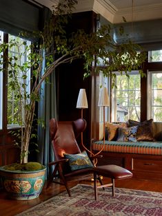 a living room filled with furniture and a tree