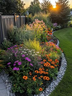 a garden filled with lots of flowers next to a fence