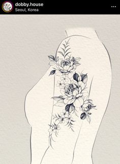 the back of a woman's arm with flowers and leaves on it, in black and