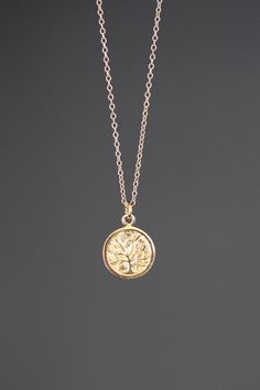 This beautifully detailed bright 24k gold vermeil Tree of Life Coin charm dangles from a 14k gold filled chain.   Choose from a 1mm 14k gold filled chain with a gold spring ring clasp, or a 1.5mm 14k gold filled chain with a gold lobster clasp. Each chain measures 16" with an extension to 18".  Please send a message if a different length chain is desired. A lovely gift for anyone of any age.  Gold Tree of Life pendant: 11.5mm Total length of charm: 5/8" Gold chain: 1mm or 1.5mm Measurements are Nature-inspired Recycled Gold Jewelry For Gifts, Nature-inspired Recycled Gold Jewelry Gift, Everyday Gold Nature-inspired Jewelry, Nature-inspired Everyday Gold Jewelry, Everyday Nature-inspired Gold Jewelry, Gold Nature-inspired Necklace For Gift, Gold Nature-inspired Pendant Necklace, Nature-inspired Gold Pendant Necklace, Gold Charm Necklaces For Anniversaries