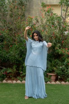 This stunning two-piece suit is perfect for party or wedding wear. The top features a beautiful ice blue leaf design, crafted from luxurious Chinnon silk. Paired with elegant gharara pants, this outfit exudes sophistication and style. It's a wonderful gift option for any woman who loves to make a statement with her fashion choices. Item - Kaftan and Gharara Fabric - Chinnon Silk Color - Ice Blue Kaftan Sleeve - Short Sleeve Kaftan Length - 29 Pants Length - 42 Size - (XS), (S), (M), (L), (XL), ( Blue Semi-stitched Palazzo Set For Reception, Blue Palazzo Set With Chikankari Embroidery For Reception, Semi-stitched Blue Palazzo Set For Reception, Blue Chikankari Embroidery Palazzo Set For Reception, Blue Palazzo Set With Sheer Dupatta For Reception, Anarkali Blue Palazzo Set For Reception, Blue Anarkali Palazzo Set For Reception, Blue Georgette Sharara For Reception, Blue Palazzo Saree Set For Wedding