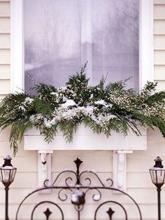 a window box filled with flowers and greenery