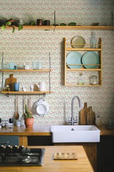 the kitchen is clean and ready for us to use it's counter tops are lined with dishes