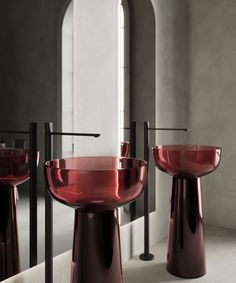 two red glass sinks sitting next to each other