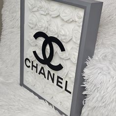 a chanel logo is displayed on a white furnishing with black and grey trim